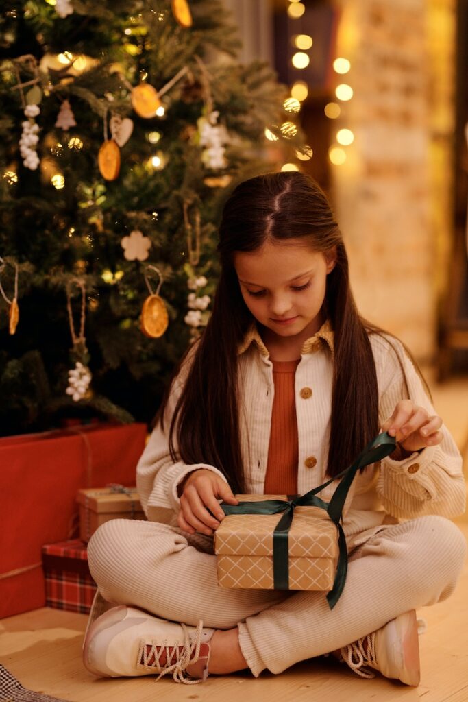Young girl opening a Christmas gift